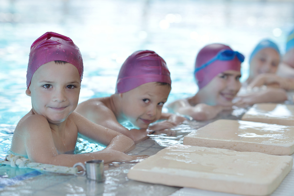 happy children group at swimming pool